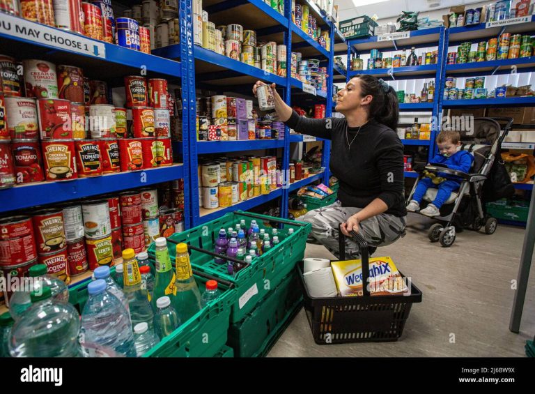 mother-with-her-son-at-a-food-bank-at-a-community-centre-in-england-2J6BW9X